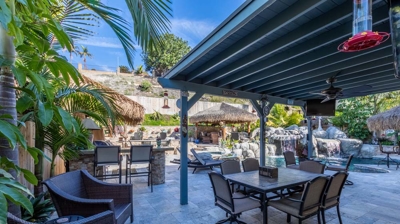 Relaxing outdoor lounge space with cozy tiki-inspired seating Photo