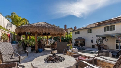 Tiki-themed outdoor seating area with comfortable chairs and beachy vibes Photo