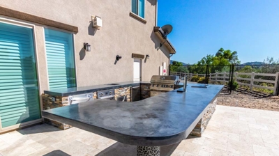 Outdoor kitchen featuring a grill, oven, and taps for versatile cooking Photo