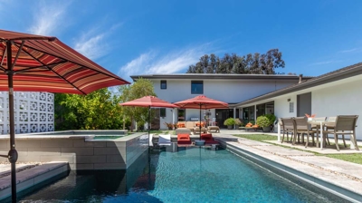 Rectangular pool and hot tub nestled in a suburban backyard oasis Photo