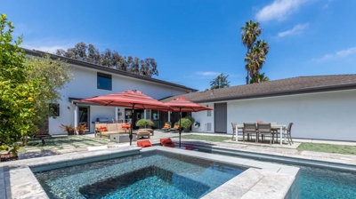 Tranquil retreat with a rectangular pool and hot tub in a suburban setting Photo