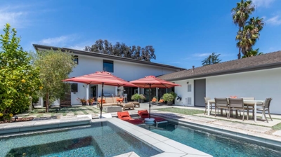 Backyard paradise showcasing a rectangular pool and hot tub in a suburban area Photo