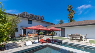 Serene suburban escape with a rectangular pool and hot tub surrounded by greenery Photo