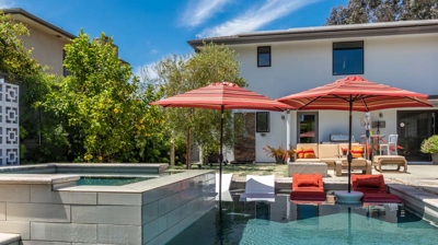 Inviting suburban backyard scene with a rectangular pool and hot tub Photo