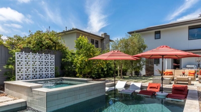 Backyard sanctuary with a rectangular pool and hot tub, perfect for relaxation Photo