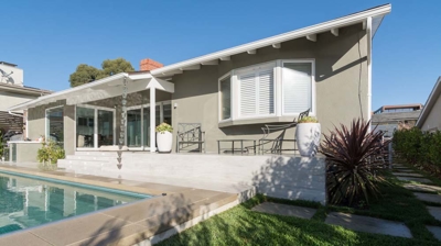 Sunny day by the pool: rectangular pool and hot tub in a suburban backyard Photo