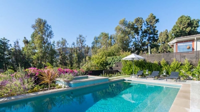 Relaxing backyard retreat: rectangular pool and hot tub in a suburban oasis Photo