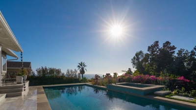 A tranquil oasis: rectangular pool and hot tub offering relaxation in a suburban backyard Photo
