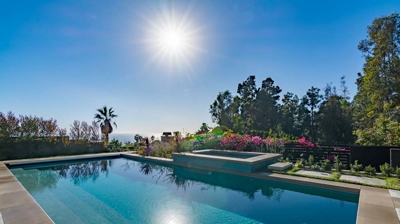 Tranquil backyard retreat: rectangular pool and hot tub offering relaxation and rejuvenation Photo