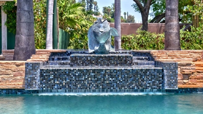 Tiled waterfall with fish statue Photo
