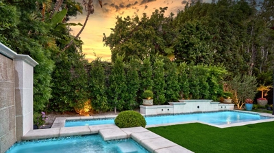 A sunset view of a jacuzzi with the pool in the background Photo