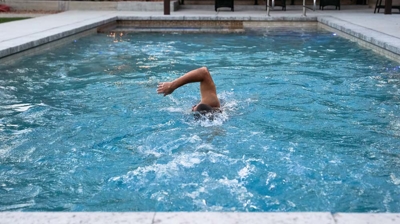 A swimmer doing laps in a pool Photo