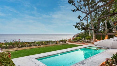 A view of the pool from further away with the ocean in view Photo