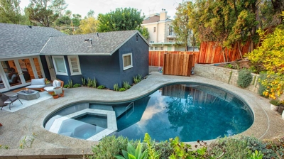Top view of curvy pool with built in geometric shaped jacuzzi Photo