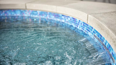 Interior tile work of a pool and a small waterfall Photo
