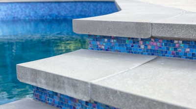 Exterior blue tile on steps outside a pool Photo