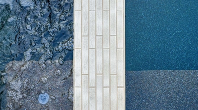 A tiled pool wall divider between a spa and a pool Photo