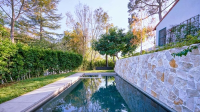 Side view of a long rectangular pool surrounded by a walkway Photo