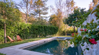 A backyard pool surrounded by a path Photo
