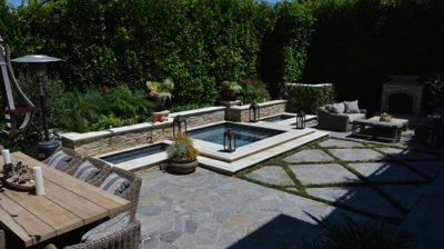 A built in spa with a path of cement pavers in a diamond pattern Photo