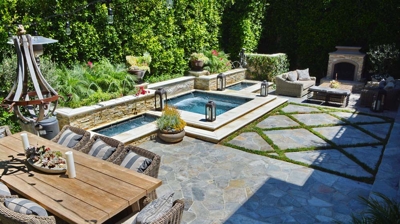 View of a backyard with a dining table with a spa in the background Photo