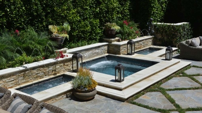 Spa with two small waterfall basins on the side Photo