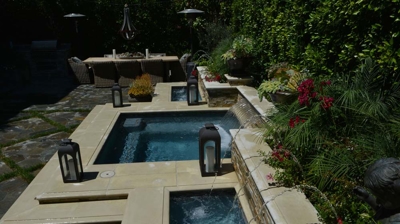 Side view of a spa with two small waterfall basins on the side Photo