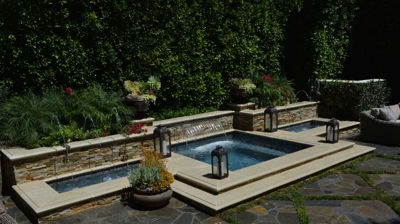 Built in jacuzzi with lanterns on steps leading up opening Photo