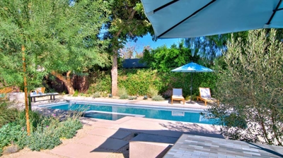 Landscaping with pavers and sand near a pool Photo