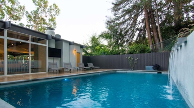Tranquil retreat: rectangular pool nestled amidst verdant foliage in a suburban oasis Photo