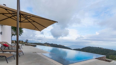 Breathtaking views from the infinity pool and hot tub of verdant mountains Photo