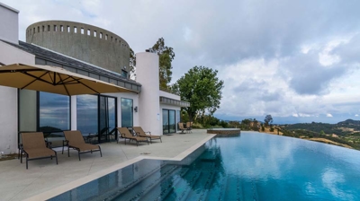 Infinity pool and hot tub providing a serene escape amidst mountainous beauty Photo