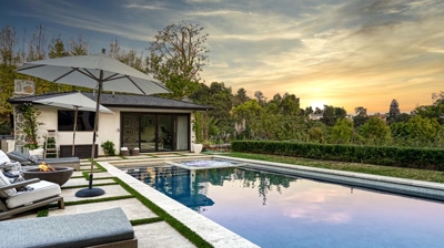 Inviting backyard scene with a pristine rectangular pool and jacuzzi Photo