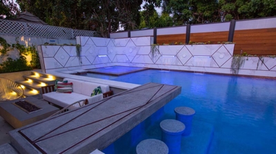 Backyard with pool and lights at dusk Photo