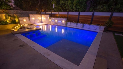 Backyard pool below string of lights Photo