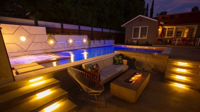 Outdoor lounge area next to pool Photo