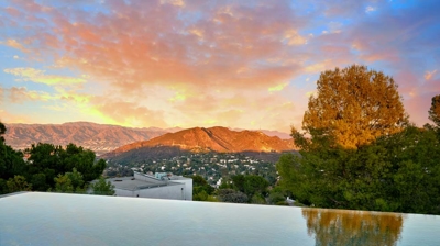 Infinity pool with a mountain view at sunset Photo
