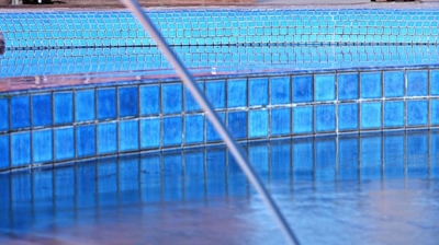 The interior of a pool with blue tiles. Photo