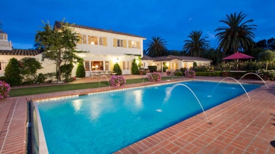 Serene pool area with a red brick surround and tranquil fountains Photo