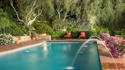 Pool fountains creating a soothing ambiance amidst lush greenery Photo