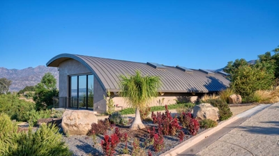 Lap pool building from the outside with landscaping Photo