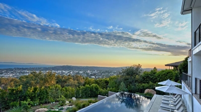 Infinity pool with view and pool deck seating Photo