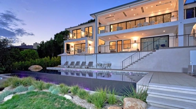 Modern infinity pool and home at night Photo