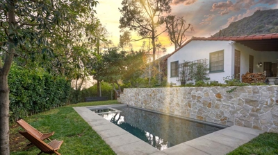 View of home and modern backyard pool Photo