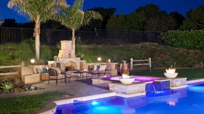 Poolside patio area with custom fireplace Photo