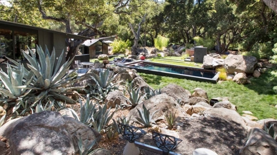 High desert vegetation framing a glittering tile pool Photo