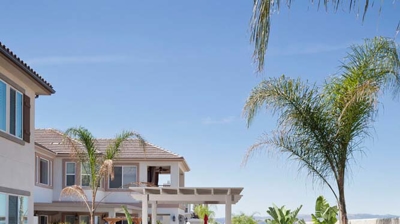 Arid pool sanctuary with palm tree and spa featuring a fire pit. Photo