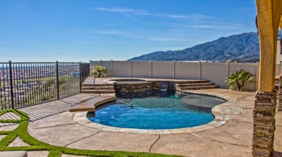 Desert-inspired backyard pool with water elements. Photo