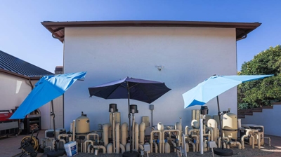 blue umbrellas and a residential house Photo