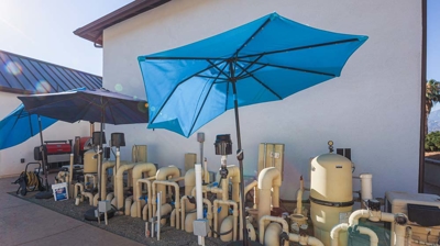 blue umbrellas and a residential house Photo